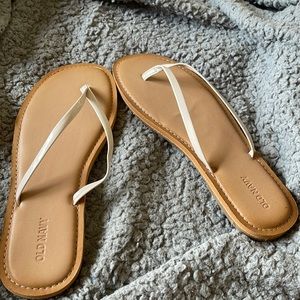 Old navy tan and light pink/cream flip flops/sandals.